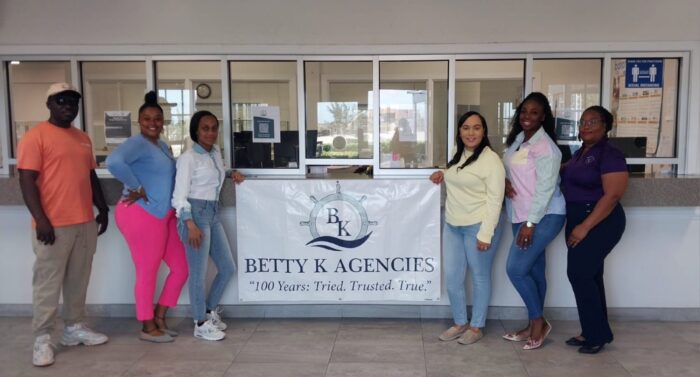 Betty K Agencies team members posing with company banner for Women's Appreciation Month